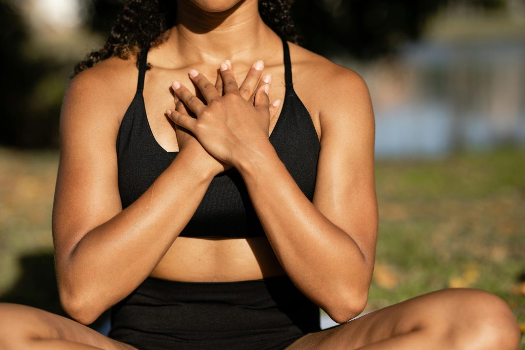 Woman embodying self-trust, holding both hands to her chest