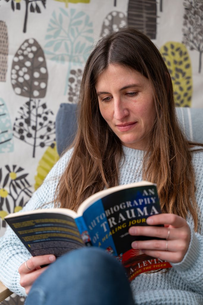 Laura holding book about page